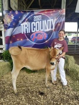 Jenna Brixey with her Grand Champion Jersey Heifer.