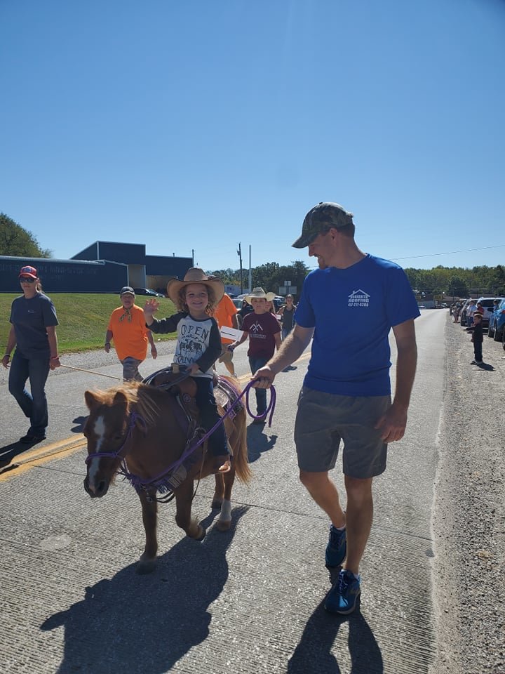 Gemma Davault is with her dad, Jeff Davault, and her horse, Elmo. They won first place in the children’s parade.