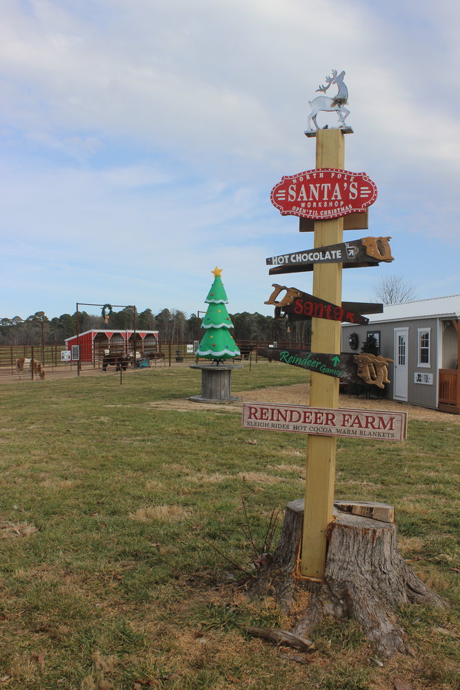 A sign points the way to the activities at the Holly Jolly Reindeer Ranch.