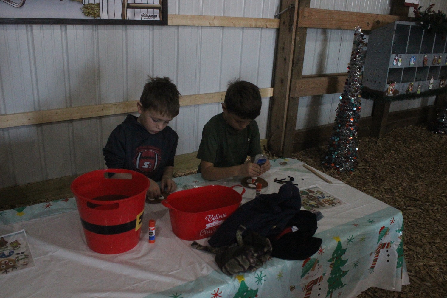 Two area kids enjoy a craft area.